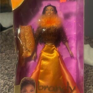 Vibrant Orange and Gold Action Figure with Flowing Dress